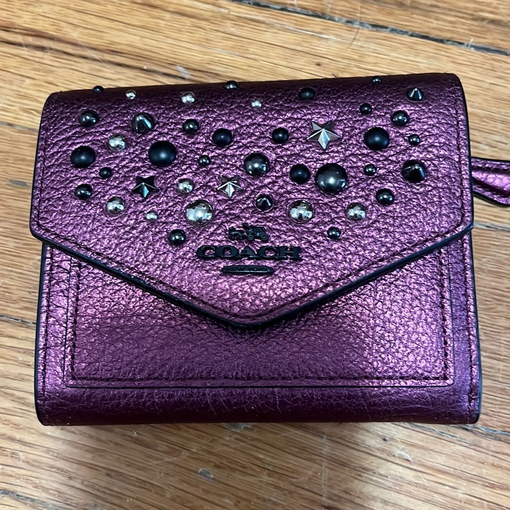 Sparkly purple Coach wallet with metal details.